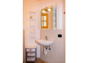a bathroom with a sink and a mirror at Casa Aurora in Cannobio
