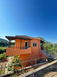 a house on a hill with a fence at Casa Limoni in Preveza +11 photos