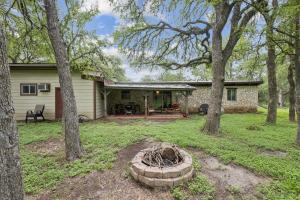 a home with a fire pit in the yard at Hill Country Getaway Near San Marcos River home in San Marcos