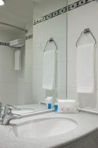 a bathroom with a sink and a mirror at Holiday Inn Maidstone-Sevenoaks by IHG in Maidstone