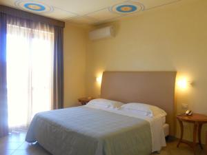 Postel nebo postele na pokoji v ubytování Hotel Saturno Fonte Pura