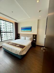 a bedroom with a bed and a large window at Khánh Phong Apartment Premire Sapphire Hòn Gai Hạ Long in Ha Long