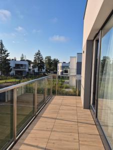 a balcony with a view of a building at Baltic Essence Apartamenty 2 in Przewłoka