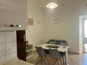 a kitchen with a table and chairs in a kitchen at Domo Mea in Cardedu