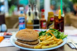 a plate of food with a hamburger and french fries at Hotel Aqua in Marmaris