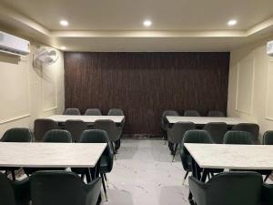 a conference room with tables and chairs in it at Rudram Inn in Varanasi