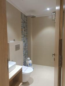 a bathroom with a toilet and a sink at Rudram Inn in Varanasi +58 photos