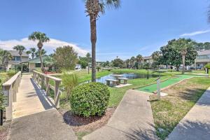 a park with a palm tree and a pathway at Cozy 2-bedroom townhouse with 11 pools in Panama City Beach