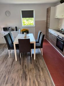 a kitchen with a dining room table and chairs at House Sweet stay by Deda Ferda late self check in in Draganići +10 photos