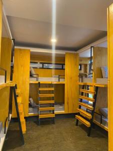 a room with lots of bunk beds with ladder at Journey Inn in General Luna +5 photos