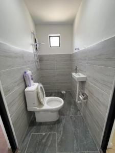 a bathroom with a toilet and a sink at Ling Dream Home in Sitiawan in Sitiawan +4 photos