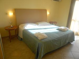 Postel nebo postele na pokoji v ubytování Hotel Saturno Fonte Pura