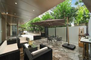 an outdoor patio with a table with an umbrella at Rezen Borui Hotel Guangzhou Zhengjia Plaza Sports Center Branch in Guangzhou