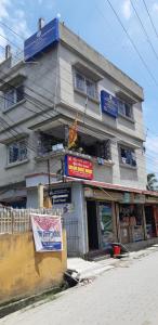 a building with a sign in front of it at Bridhi Guest House in Siliguri