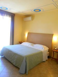 Postel nebo postele na pokoji v ubytování Hotel Saturno Fonte Pura