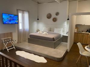 a bedroom with a bed and a tv on the wall at Rhodes Old Town Harmony Suite in Rhodes Town