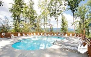 a large swimming pool with chairs around it at Tennessee Treasure in Pigeon Forge