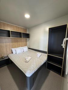 a bedroom with a bed with two towels on it at StayAdriatic Mobile Homes Olive in Sveti Filip i Jakov