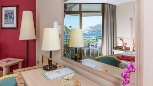 a room with a table and a mirror and a room at Hotel Aqua in Marmaris