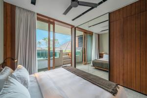 a bedroom with a large bed and a large window at Body Factory Lifestyle Residence Uluwatu in Uluwatu +35 photos