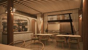 a restaurant with tables and chairs in a room at Cher resort Maldives in Kamadhoo