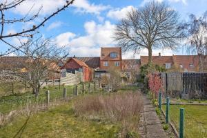 a farm with a fence and houses in the background at 4221-Stege-Langgade-21 in Stege