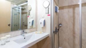 a bathroom with a sink and a shower at Hotel Aqua in Marmaris