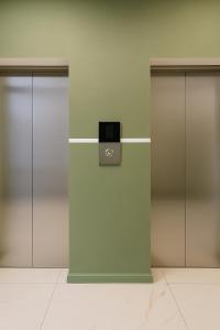 a row of three elevators in a building at Evergreen Stay Dilijan in Dilijan +10 photos