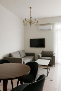 a living room with couches and a table and a tv at Evergreen Stay Dilijan in Dilijan +10 photos