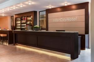 a lobby of a hotel with a reception counter at IntercityHotel Essen in Essen