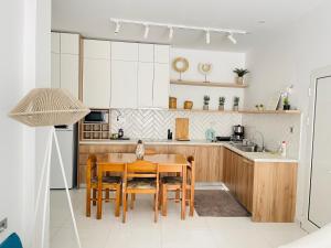 a kitchen with a wooden table and a dining room at Marion Holiday House in Alykes