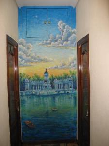 a painting on the wall of a bathroom at Hostal Maria Cristina in Madrid