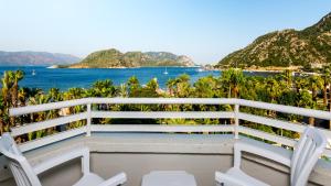 a balcony with chairs and a view of the ocean at Hotel Aqua in Marmaris