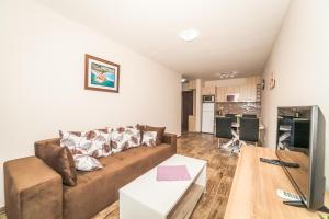 a living room with a couch and a table at Milara Apartments in Budva