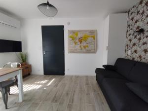a living room with a couch and a table at studio des olivières in Montpeyroux