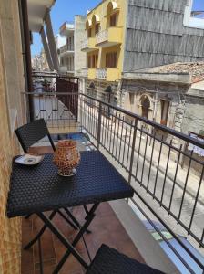 a table and chairs on a balcony with a view at Medea in Floridia