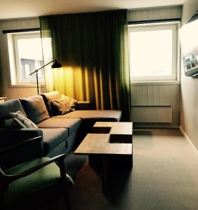 a living room with a couch and a coffee table at Kittelfjäll Vandrarhem in Kittelfjäll
