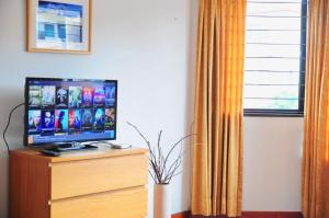 a television sitting on top of a dresser with a window at GRAYHAUS 32 Spacious 3 Storey 5BR - Bandar Utama, near 1 Utama - Stay Only NO EVENTS in Petaling Jaya
