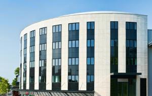 a large white building with a lot of windows at Ténéo Apparthotel Talence Arthena in Talence