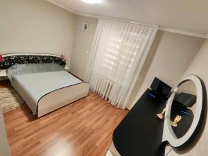 a small bedroom with a bed and a mirror at DOR de CIMIȘLIA in Cimişlia