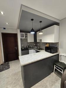 a kitchen with white cabinets and a counter top at Luxury chalet in Porto Golf for rent in El Alamein