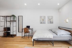 a bedroom with a bed and a desk and a chair at Global Bnb - Ay Homes in Augsburg