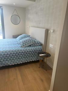 Schlafzimmer mit einem Bett und einem Beistelltisch in der Unterkunft Villa proche Lac in Écharvine + 13 Fotos