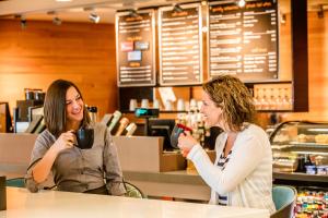 two women sitting at a counter drinking coffee at Lodge Geneva National in Lake Geneva +32 photos
