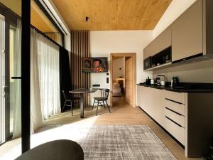 a kitchen and living room with a table and chairs at ELVA PREMIUM APARTMENT HOTEL inklusive Sommerpass STUBAI SUPER CARD in Neustift im Stubaital +128 photos