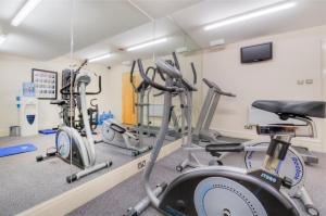 a gym with several exercise bikes in a room at Holyrood Aparthotel in Edinburgh