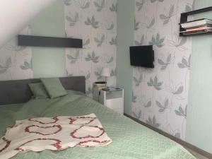 a bedroom with a bed and a television in it at Haus Matti in Meuro +19 photos