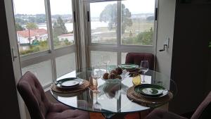 a dining room table with chairs and a glass table at Fonteculler centro in Culleredo