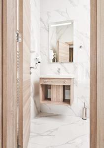 a white bathroom with a sink and a mirror at Evelin Deluxe House in Plovdiv