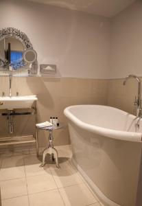 a bathroom with a large tub and a sink at Vanbrugh House Hotel in Oxford